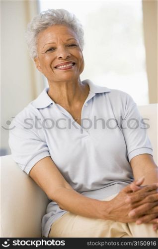 Woman sitting in living room smiling