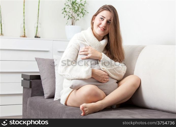 Woman sitting in livingroom on sofa with crossed legs