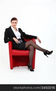 Woman sitting in red chair