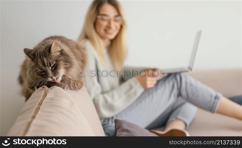 woman sitting indoors with her cat