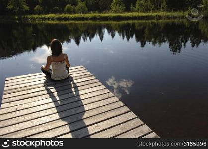 Woman sitting on a dock