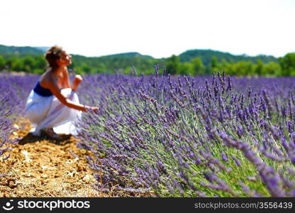 Woman sitting on a lavender field