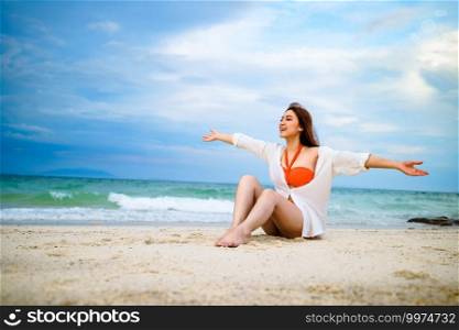 woman sitting on a sea beach at Koh MunNork Island, Rayong, Thailand