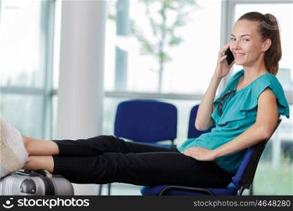 woman sitting on airport bench