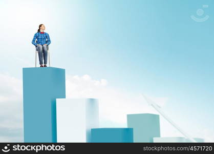 Woman sitting on bars. Young woman sitting on chair on graph bars