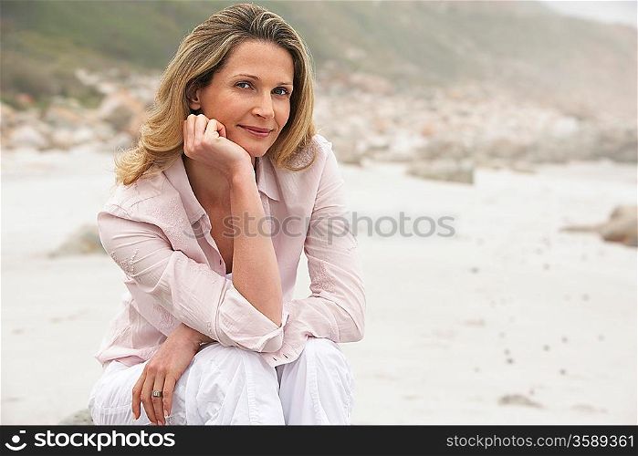 Woman sitting on beach portrait