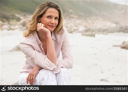 Woman sitting on beach portrait