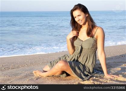 Woman sitting on beach relaxing