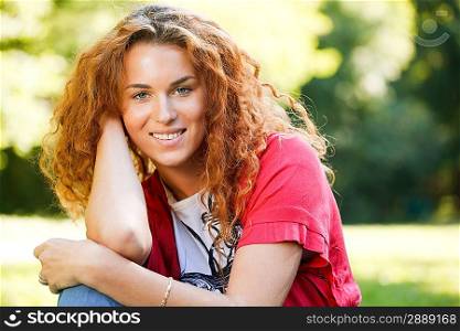 Woman sitting on grass in park
