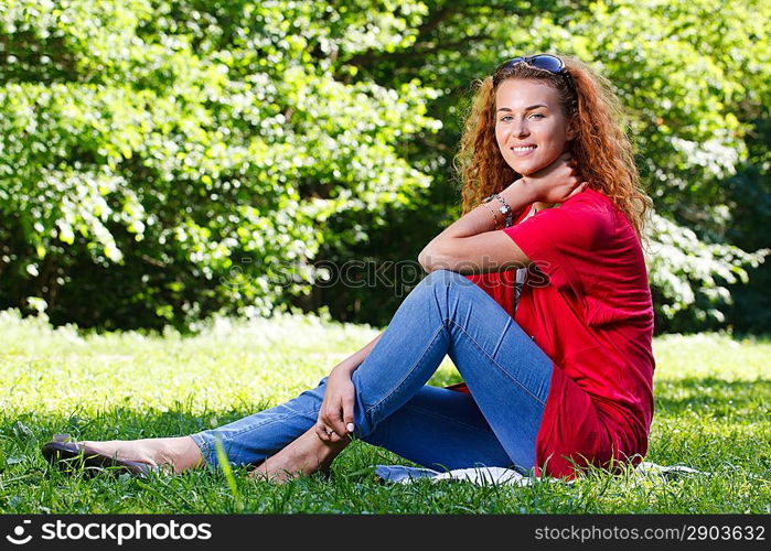 Woman sitting on grass in park