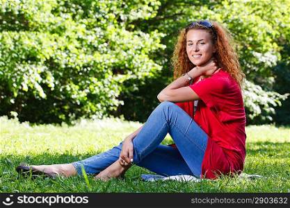 Woman sitting on grass in park