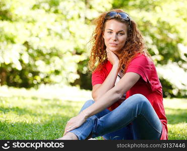 Woman sitting on grass in park