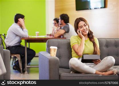 Woman Sitting On Sofa And Working In Design Studio