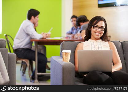 Woman Sitting On Sofa And Working In Design Studio