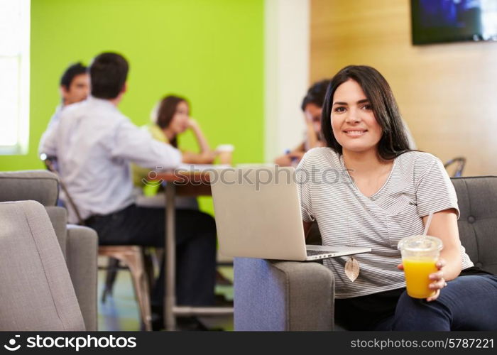 Woman Sitting On Sofa And Working In Design Studio