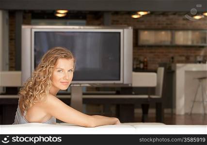 Woman Sitting on Sofa in Modern Loft Home