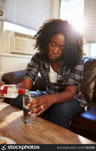 Woman Sitting On Sofa With Bottle Of Vodka