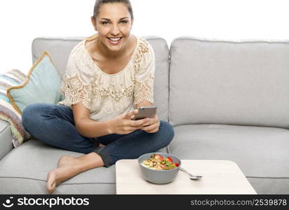 Woman sitting on the couch ready to eat and talking picture to her food