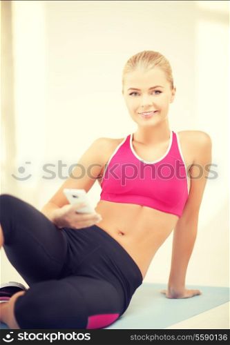 woman sitting on the floor and looking into smartphone