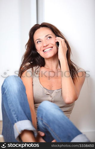 Woman sitting on the floor at home with laptop