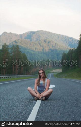 Woman sitting on the road. Woman sitting on the beauty road in mountain