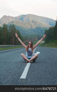 Woman sitting on the road. Woman sitting on the beauty road in mountain