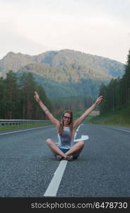 Woman sitting on the road. Woman sitting on the beauty road in mountain