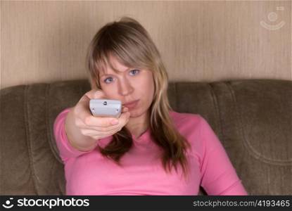 Woman sitting on the sofa and watching tv