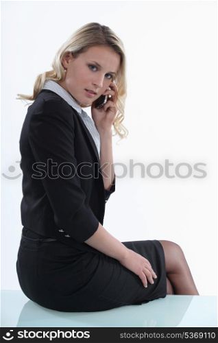 Woman sitting on the table with mobile