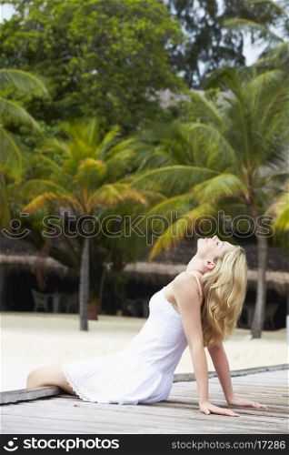 Woman Sitting On Wooden Jetty