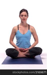 Woman Sitting on Yoga Mat With Eyes Closed