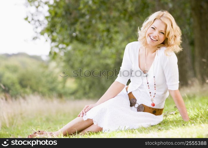 Woman sitting outdoors smiling