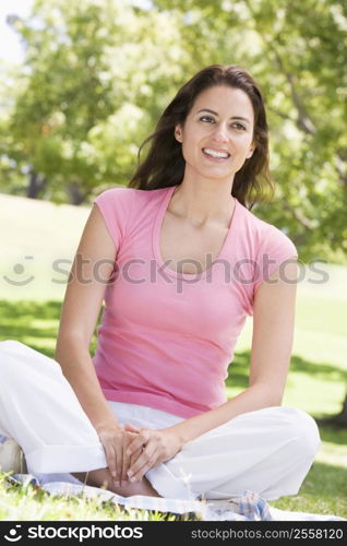 Woman sitting outdoors smiling