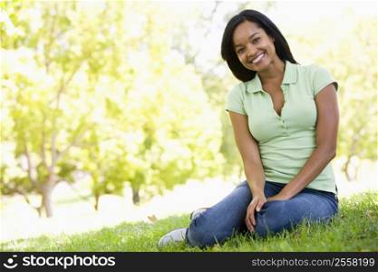 Woman sitting outdoors smiling