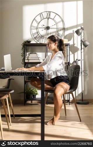 woman sitting table working laptop