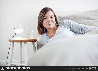 Woman sitting up in bed