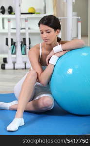 Woman sitting with an exercise ball