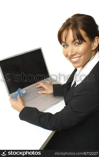 Woman sitting with laptop