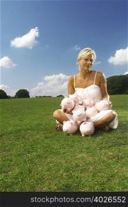 woman sitting with piggy banks