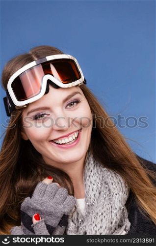 Woman skier girl wearing warm clothing ski googles portrait. Winter sport activity. Beautiful sportswoman on blue studio shot. skier girl wearing warm clothes ski googles portrait.