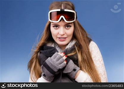 Woman skier girl wearing warm clothing ski googles portrait. Winter sport activity. Beautiful sportswoman on blue studio shot. skier girl wearing warm clothes ski googles portrait.