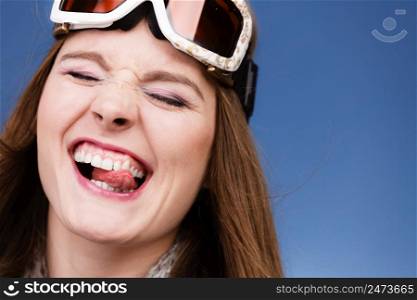 Woman skier girl wearing warm clothing ski googles portrait. Winter sport activity. Beautiful funny sportswoman blue studio shot. skier girl wearing warm clothes ski googles portrait.