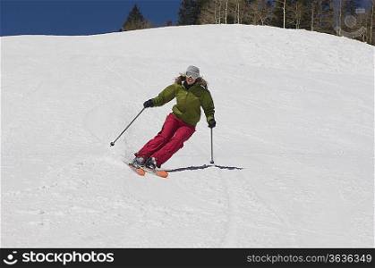 Woman Skiing Down Ski Slope