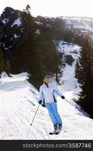 Woman skiing down slope elevated view