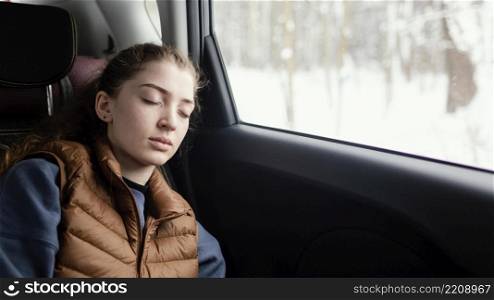 woman sleeping car while traveling