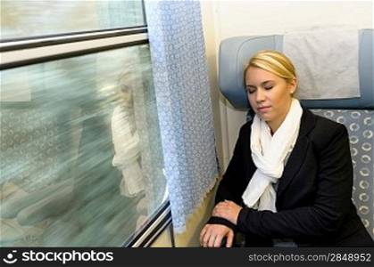 Woman sleeping in train compartment tired resting commuter comfortable journey