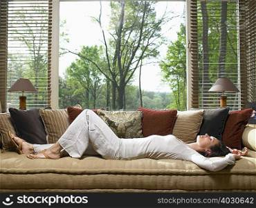 Woman sleeping on sofa in living room