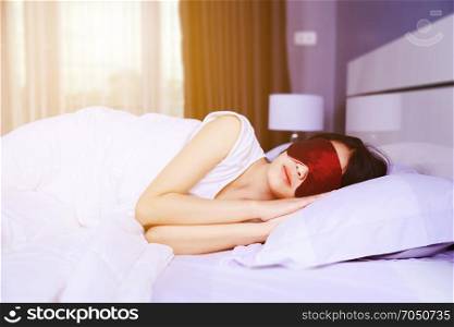 woman sleeping with eye mask on bed in the bedroom