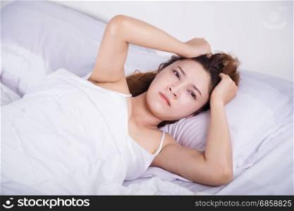 woman sleepless on bed in the bedroom