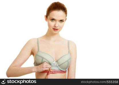 Woman slim girl in bra lingerie with red measure tape measuring her under chest breasts. Isolated on white. Woman measuring her under breasts.